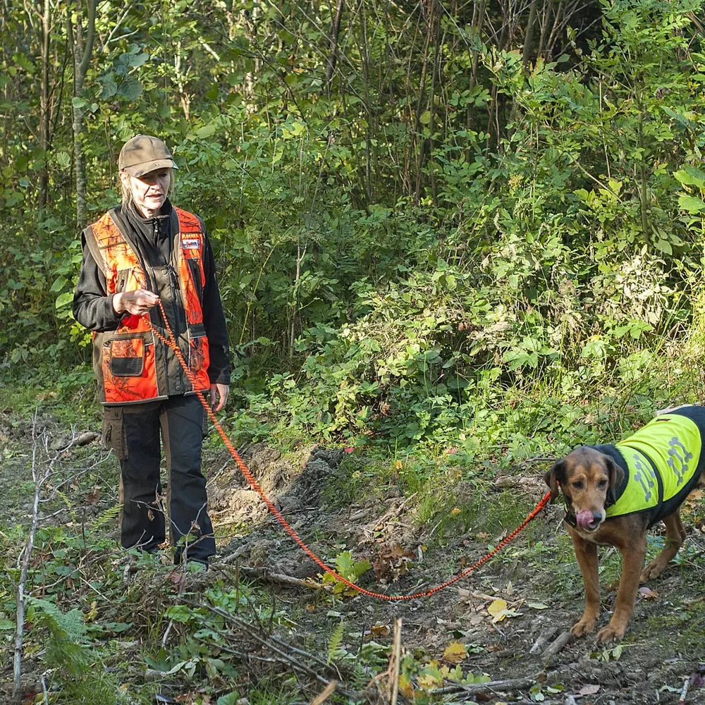 A hunter with a RunLock leash in the forest