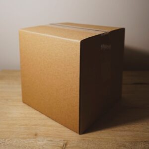 shallow focus photo of brown cardboard box